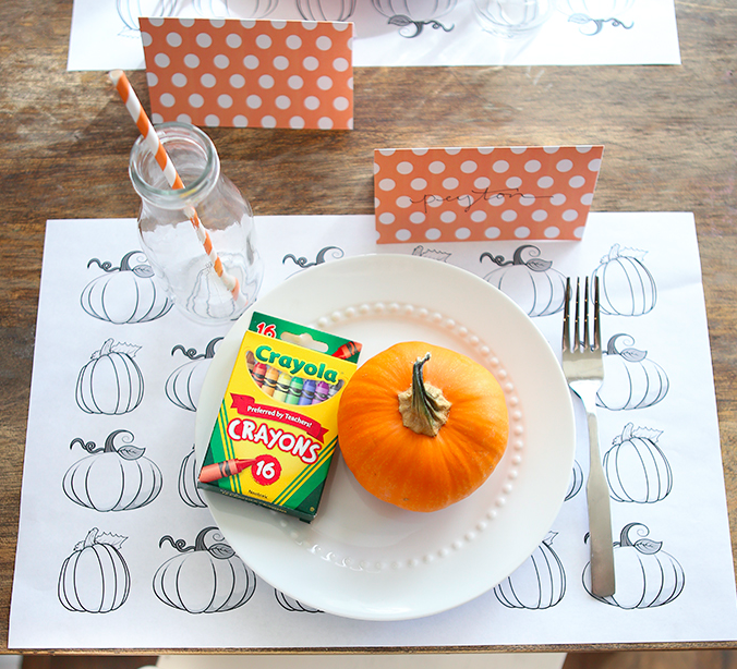 crayons and pumpkin on plate