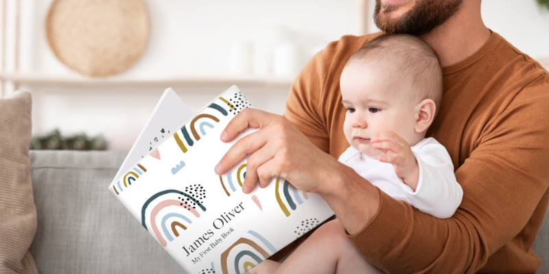 father and baby with baby book