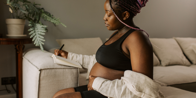 woman journaling during pregnancy