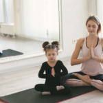 mom and daughter meditating to stay healthy during winter