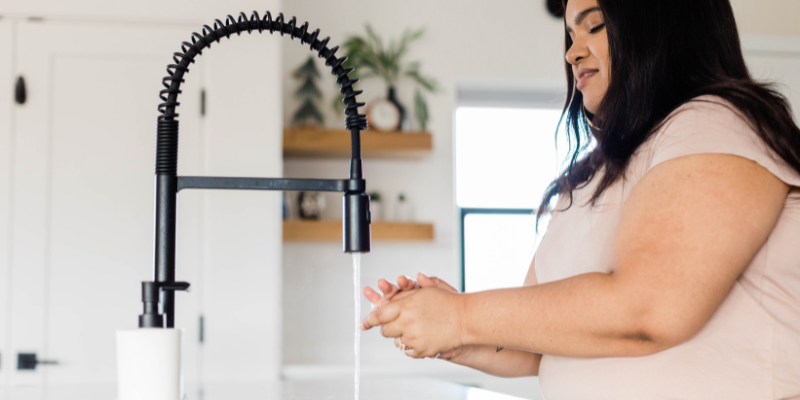 woman washing hands to stay healthy