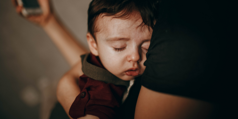 baby napping in moms arms