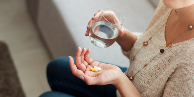 woman taking vitamins to avoid illness during pregnancy