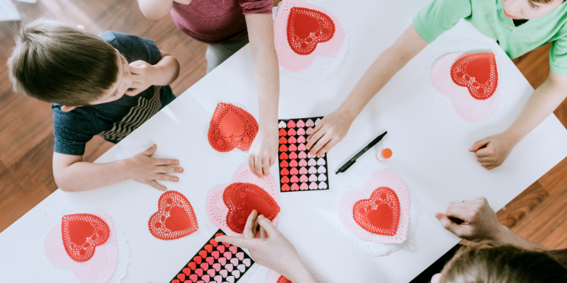 kids making homemade cards to celebrate valentine's day